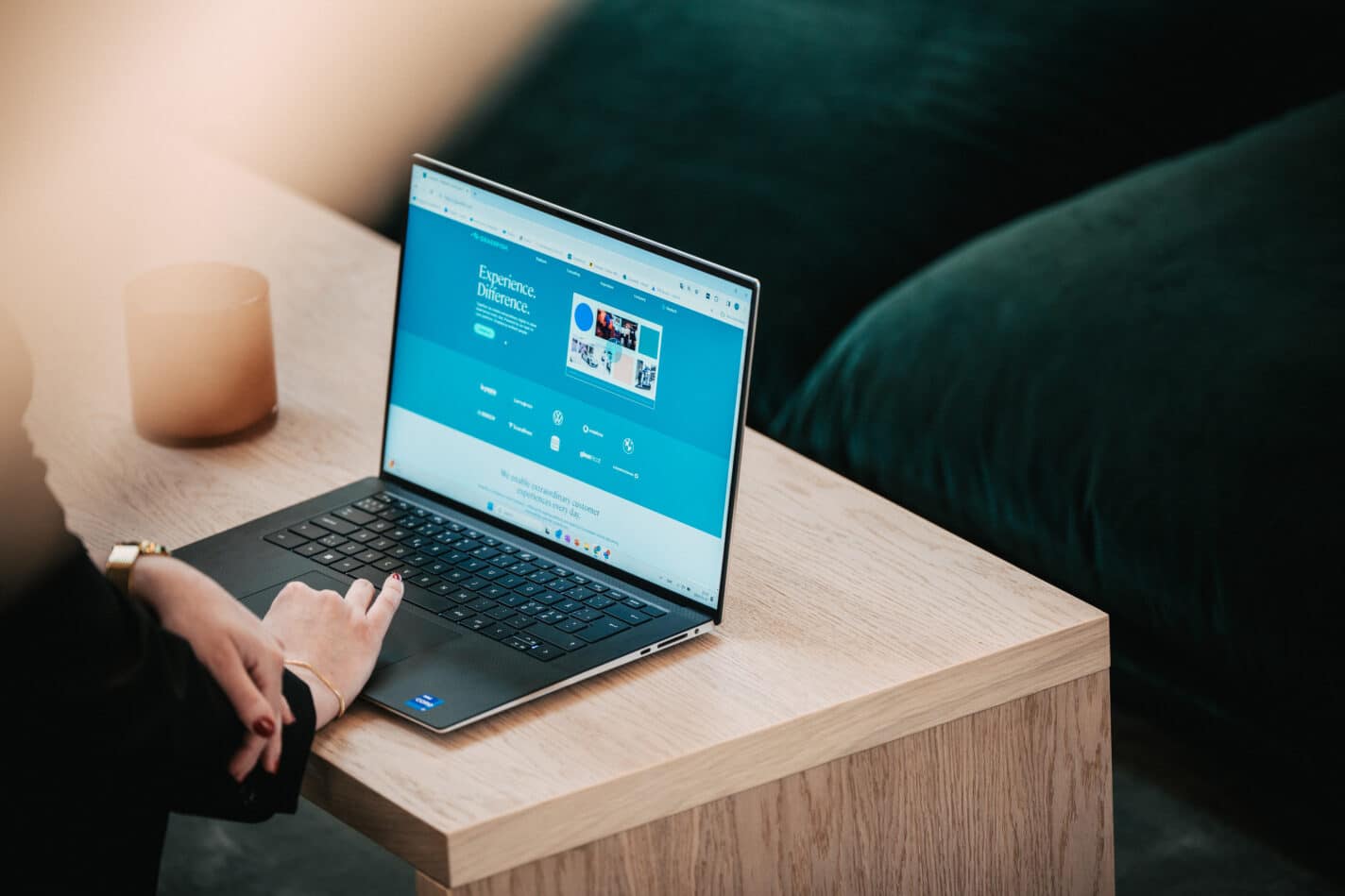 Image of computer on a table with hands touching the keyboard. Interface of Grassfish website